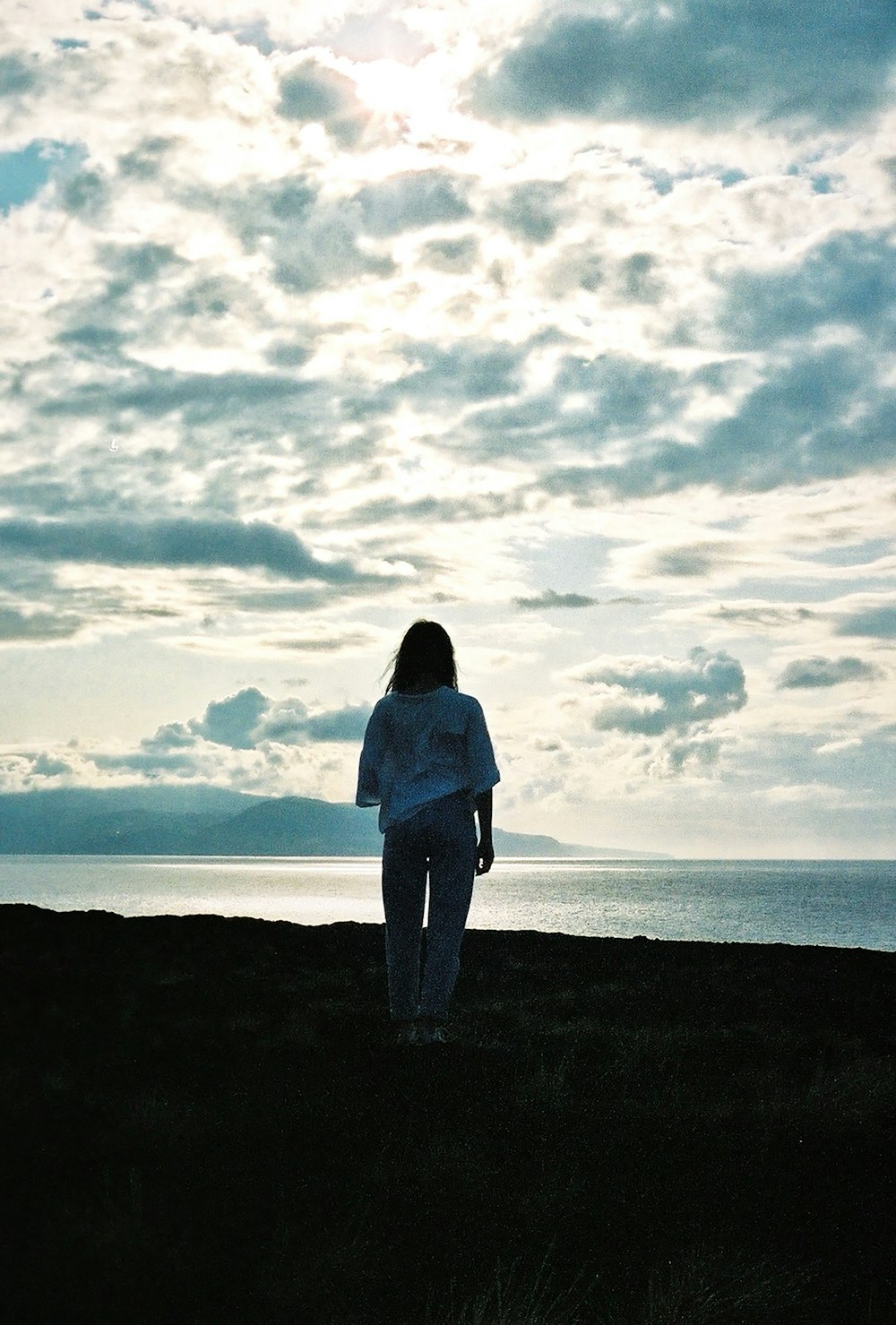 a woman standing on top of a lush green field