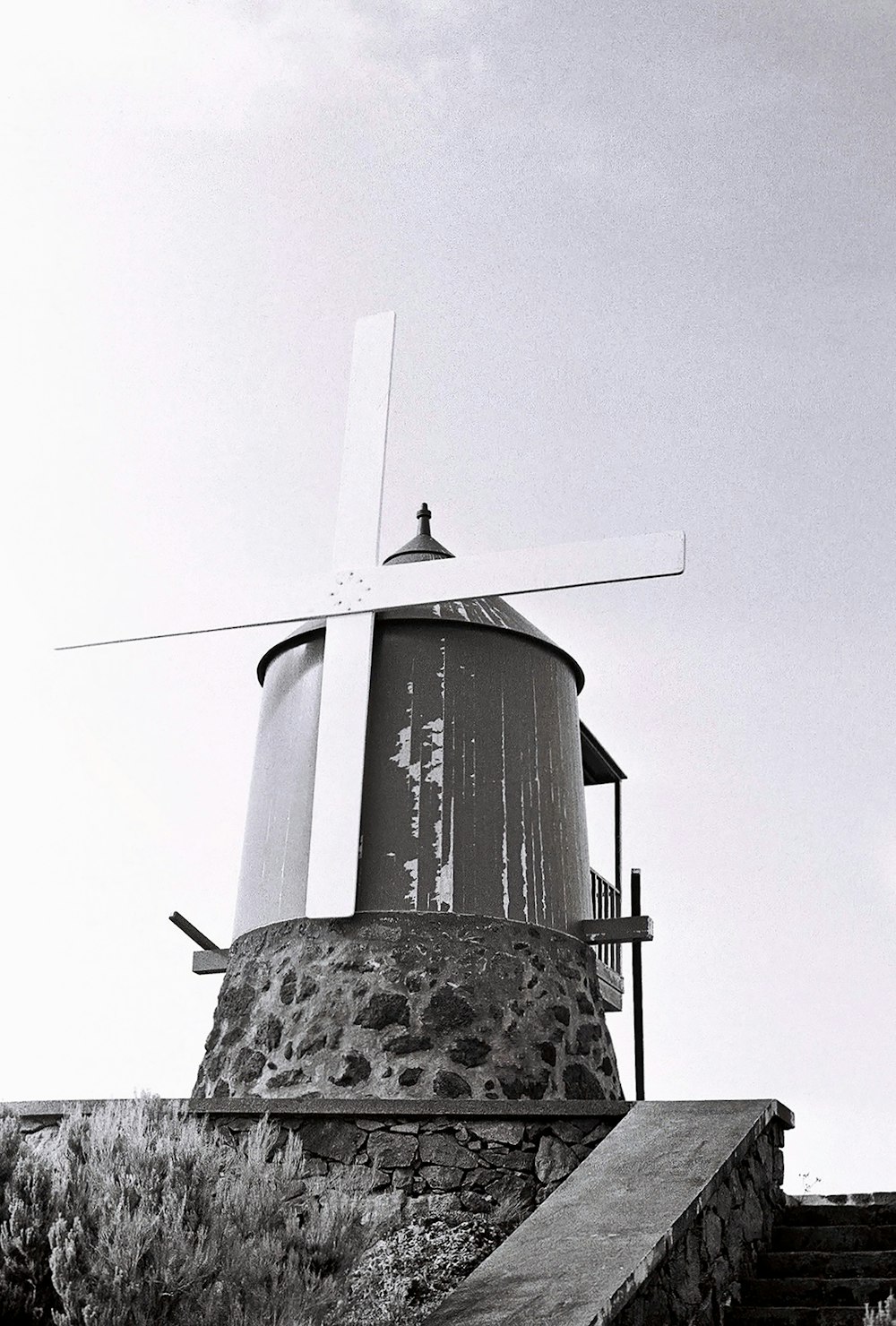 a black and white photo of a windmill
