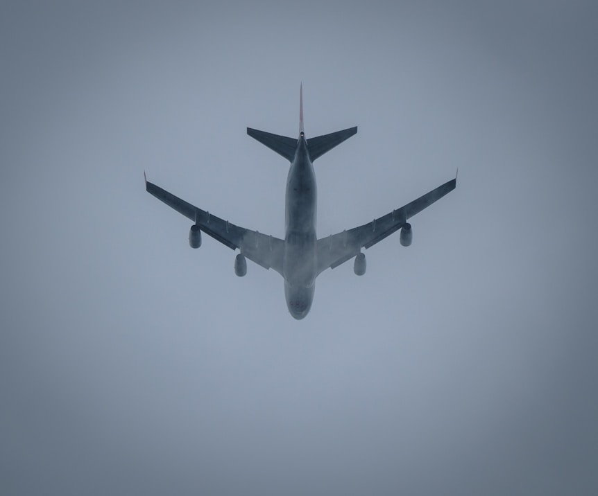 a large jetliner flying through a foggy sky