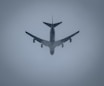 a large jetliner flying through a foggy sky