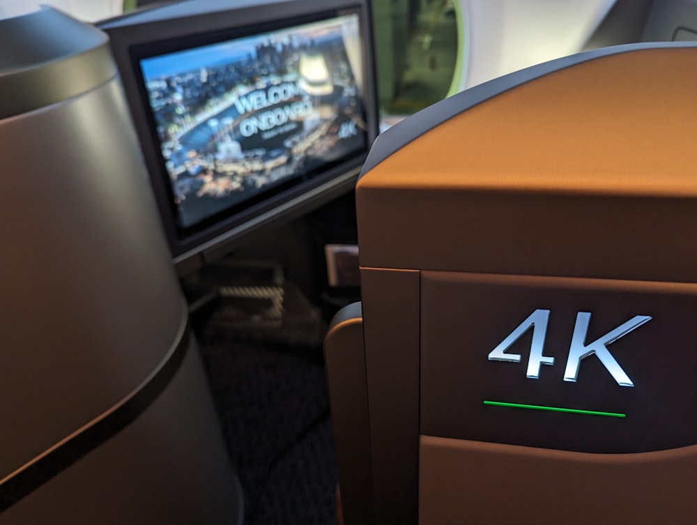 the back of an airplane seat with a television in the back