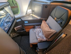 a seat on an airplane with a monitor