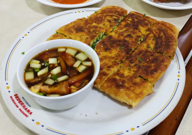 Murtabak with a cucumber-onion dip, cut into squares