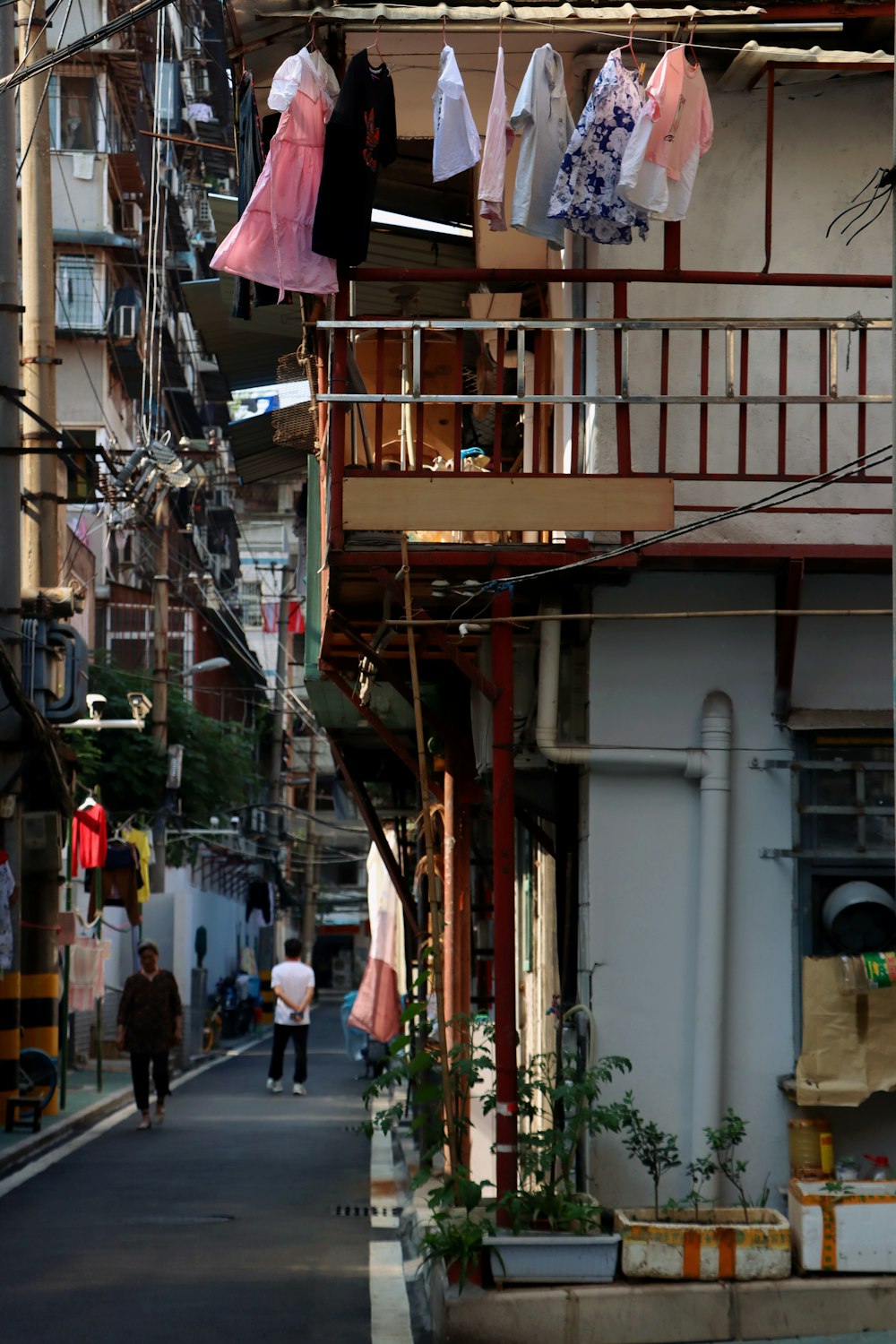 a person walking down a street next to a building