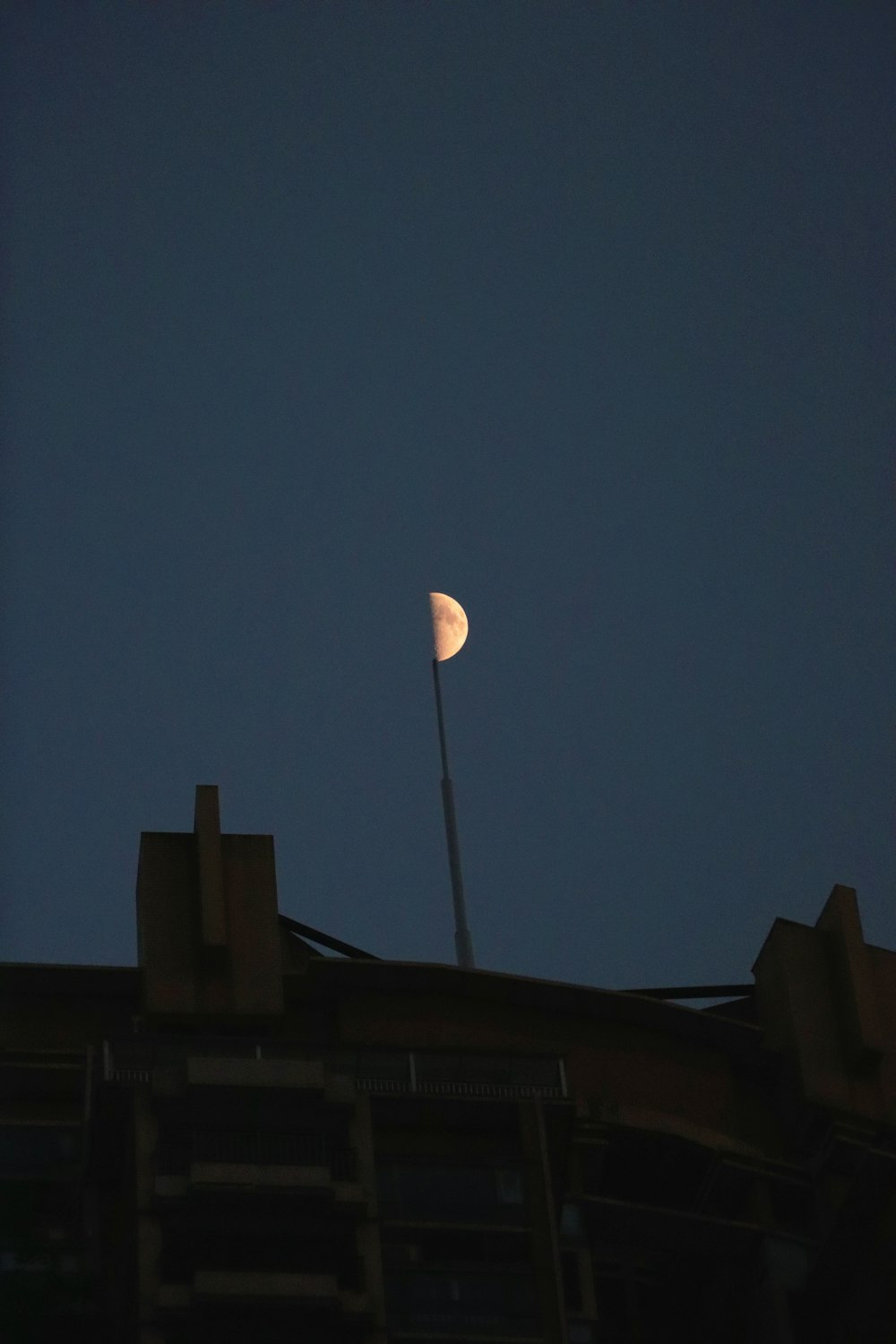 a view of the moon from the roof of a building