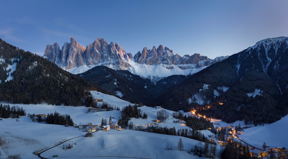 a view of a snowy mountain range at night