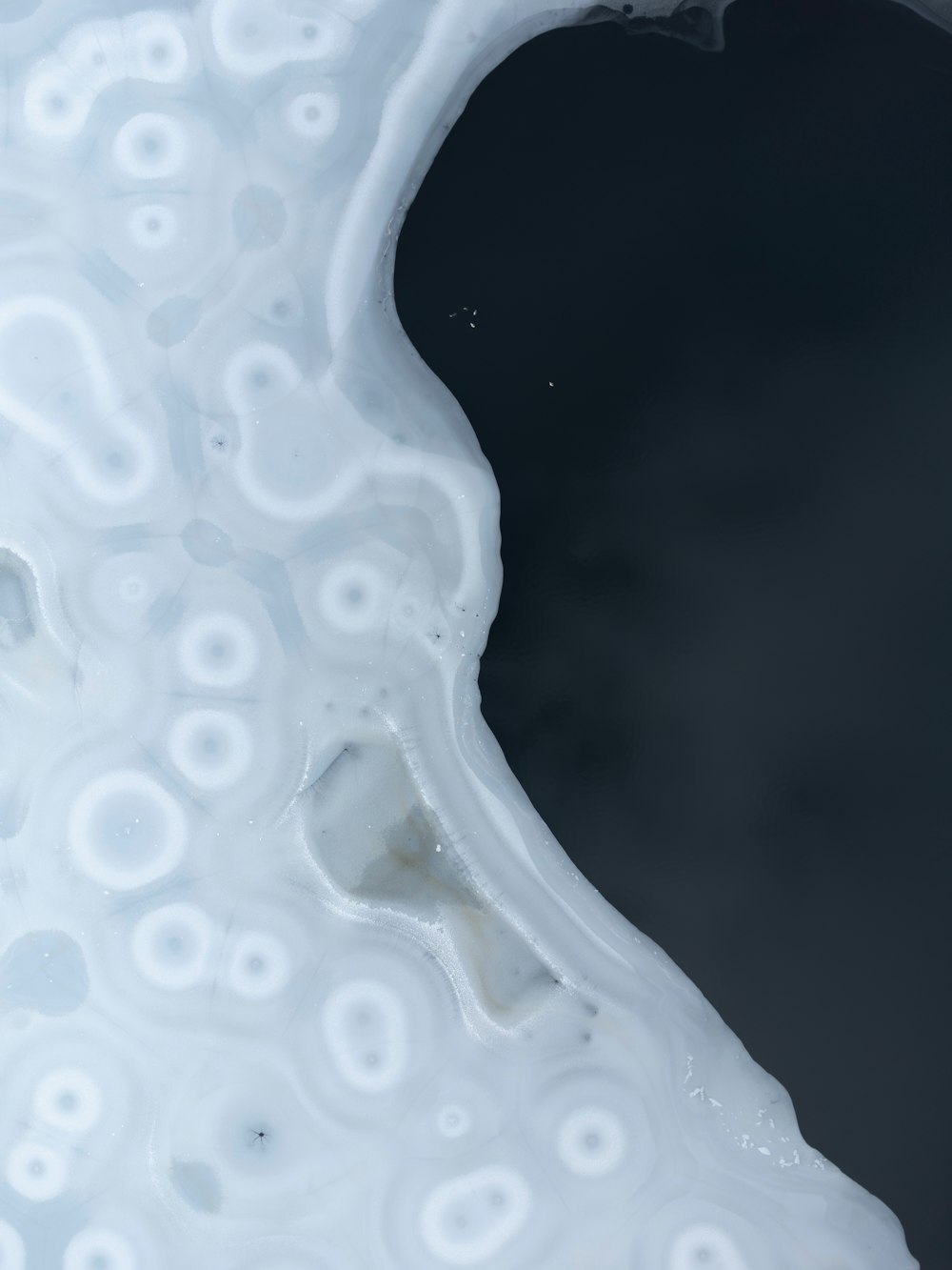 a close up of a white substance with a black background