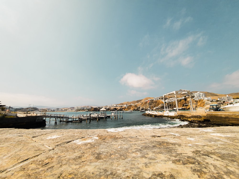 a body of water with a pier in the background