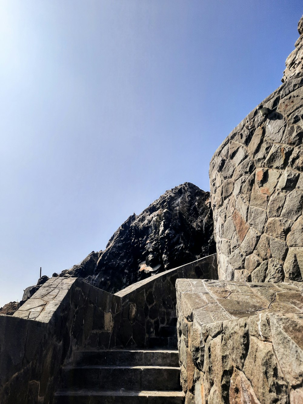 a stone wall with steps leading up to it