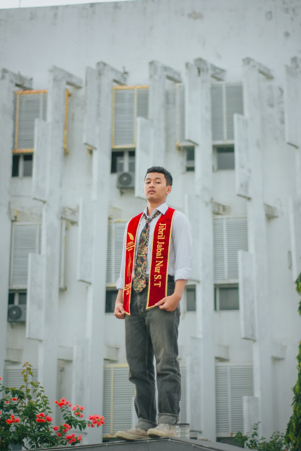 a man standing on top of a roof in front of a building