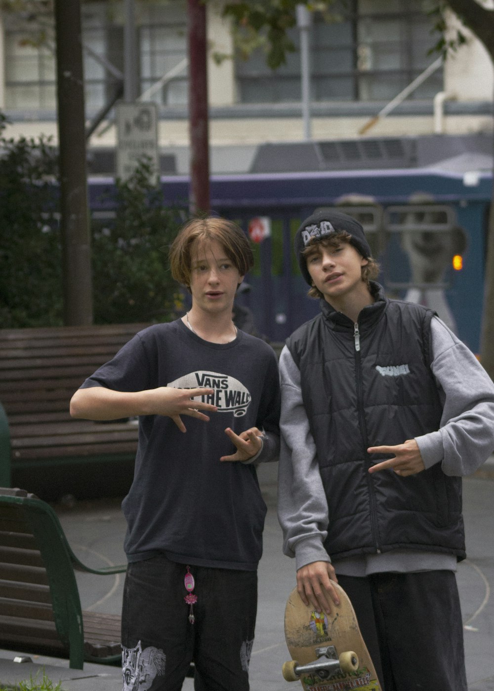 a couple of young men standing next to each other