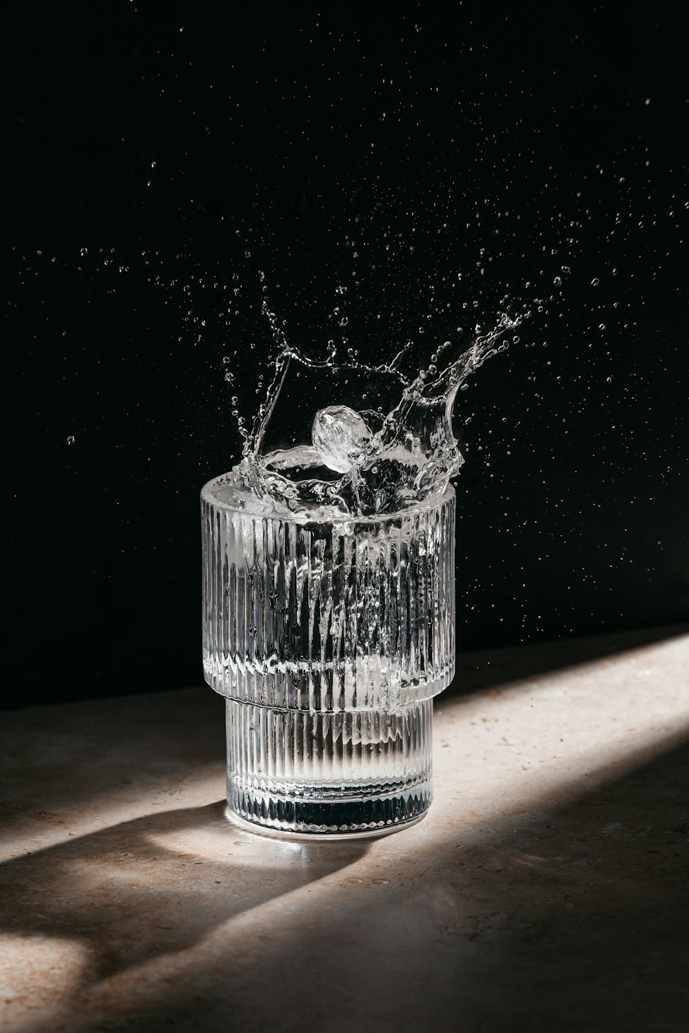 a glass filled with water on top of a table