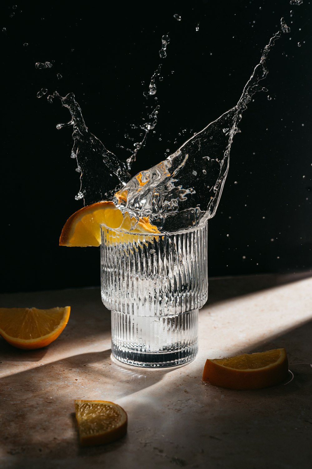 a glass of water with a slice of orange in it