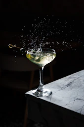 a martini with a splash of water on top of it