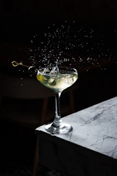 a martini with a splash of water on top of it