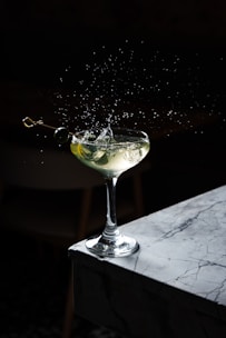 a martini with a splash of water on top of it