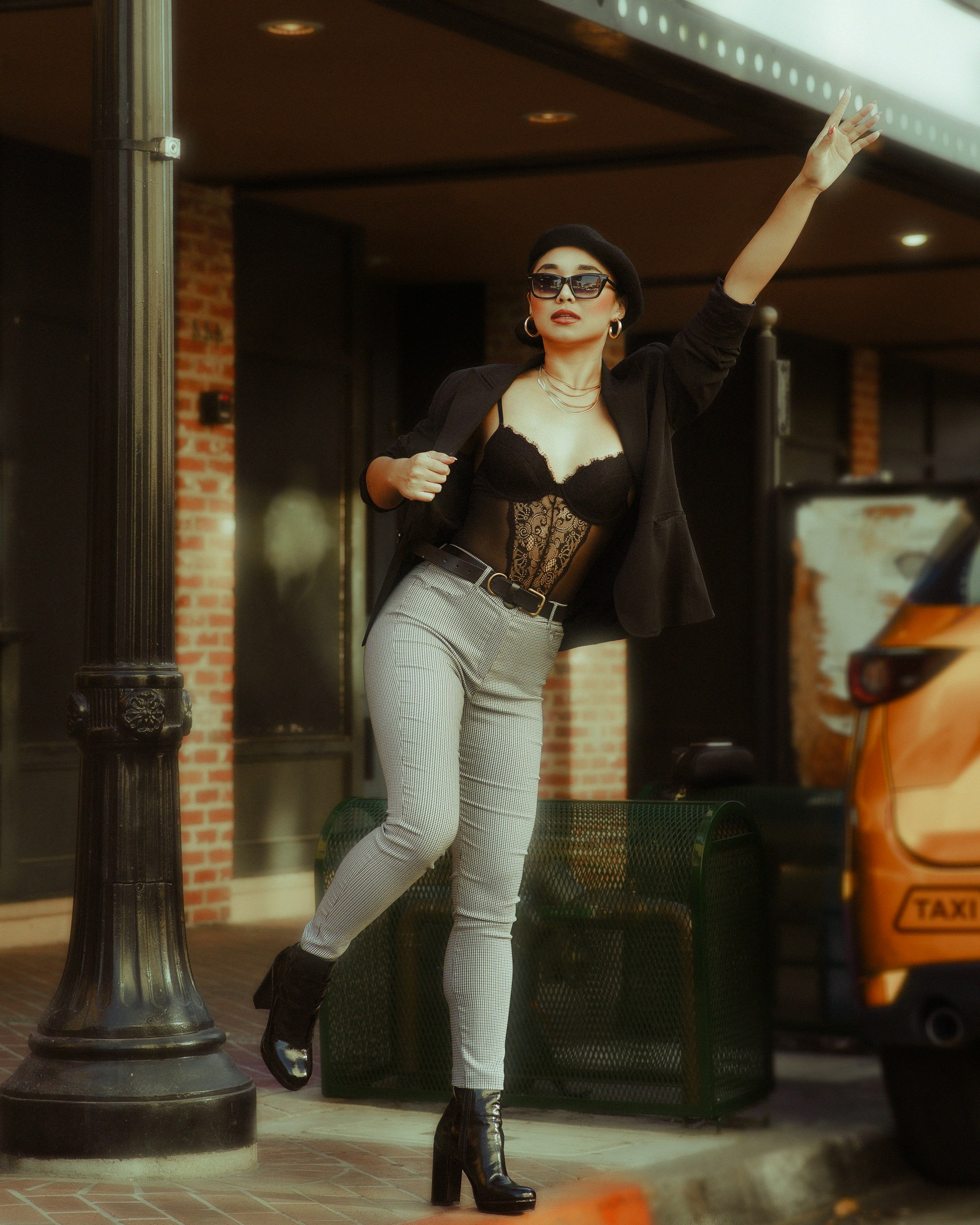 a woman in a black top and grey pants