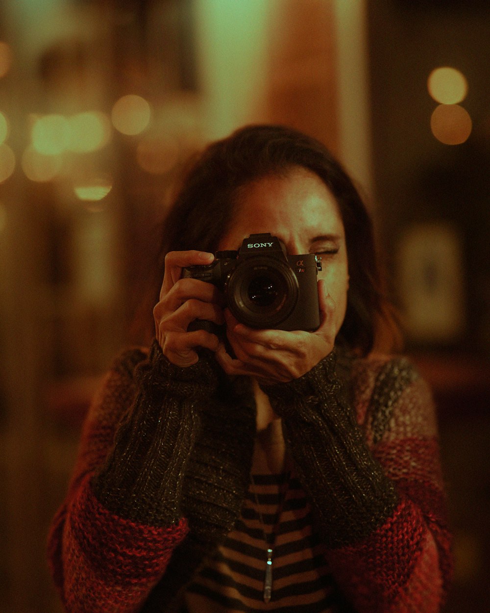 a woman taking a picture of herself with a camera