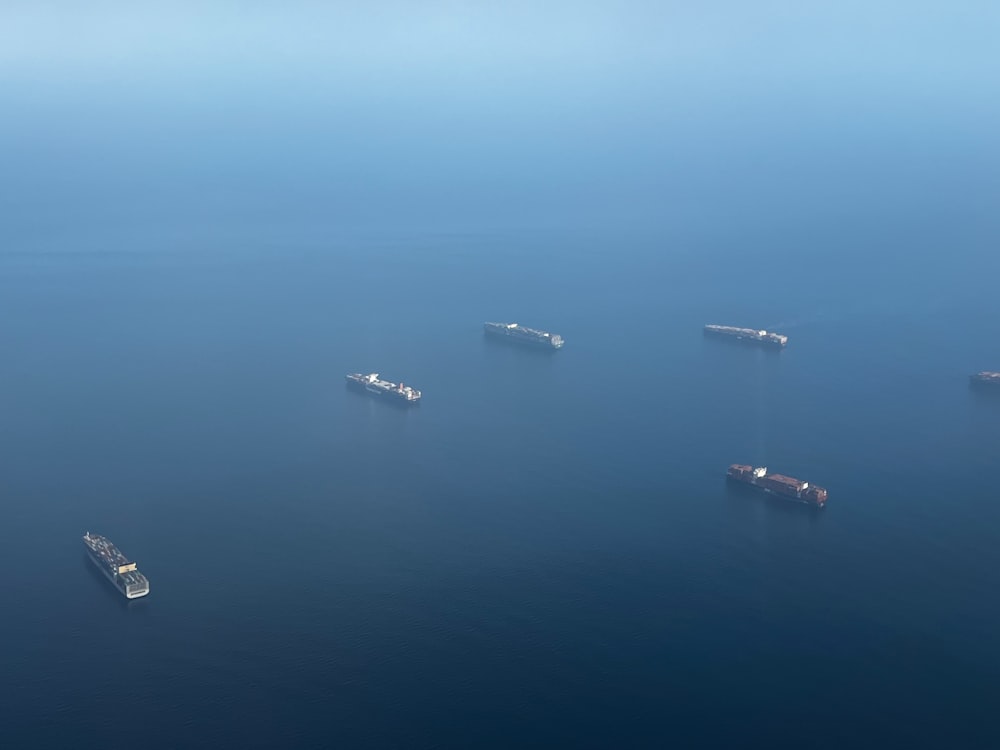 a group of ships floating on top of a body of water