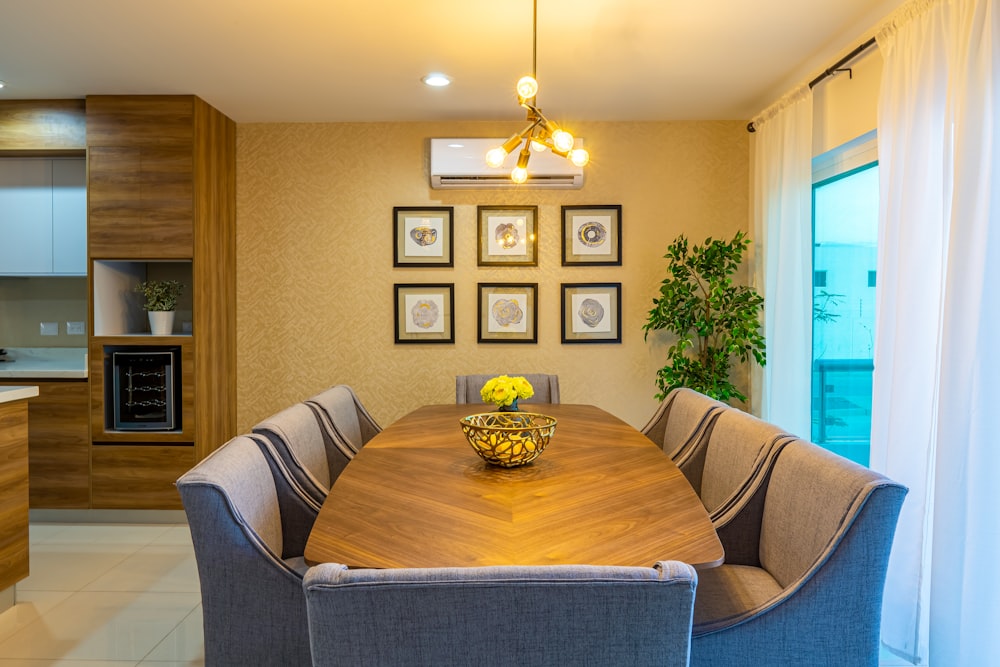 a dining room table with a bowl of flowers on it