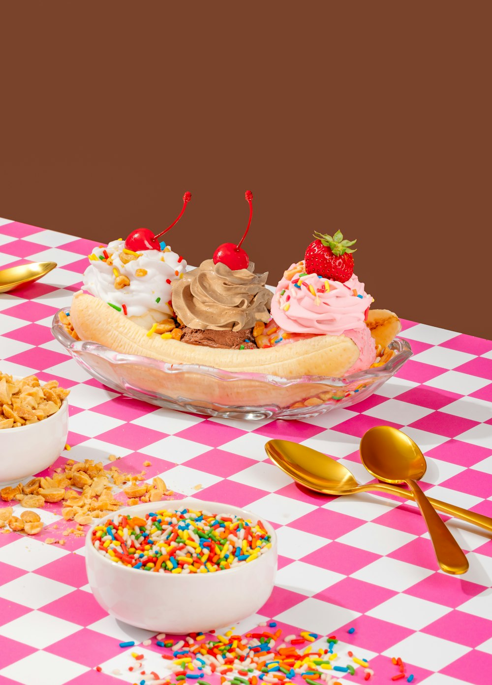 a table topped with bowls of cereal and a banana split