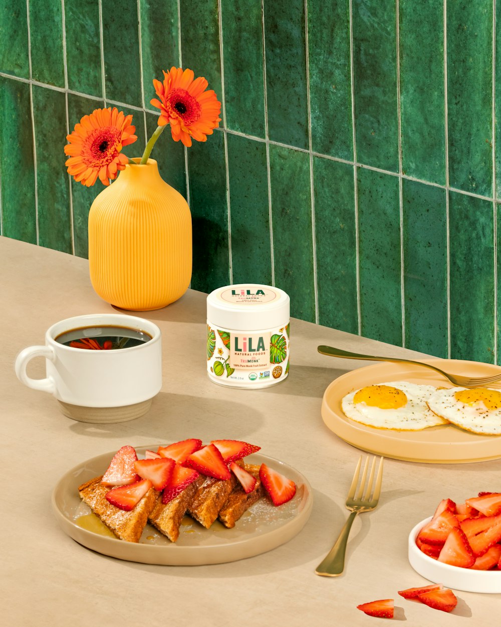 a table topped with plates of food and a cup of coffee