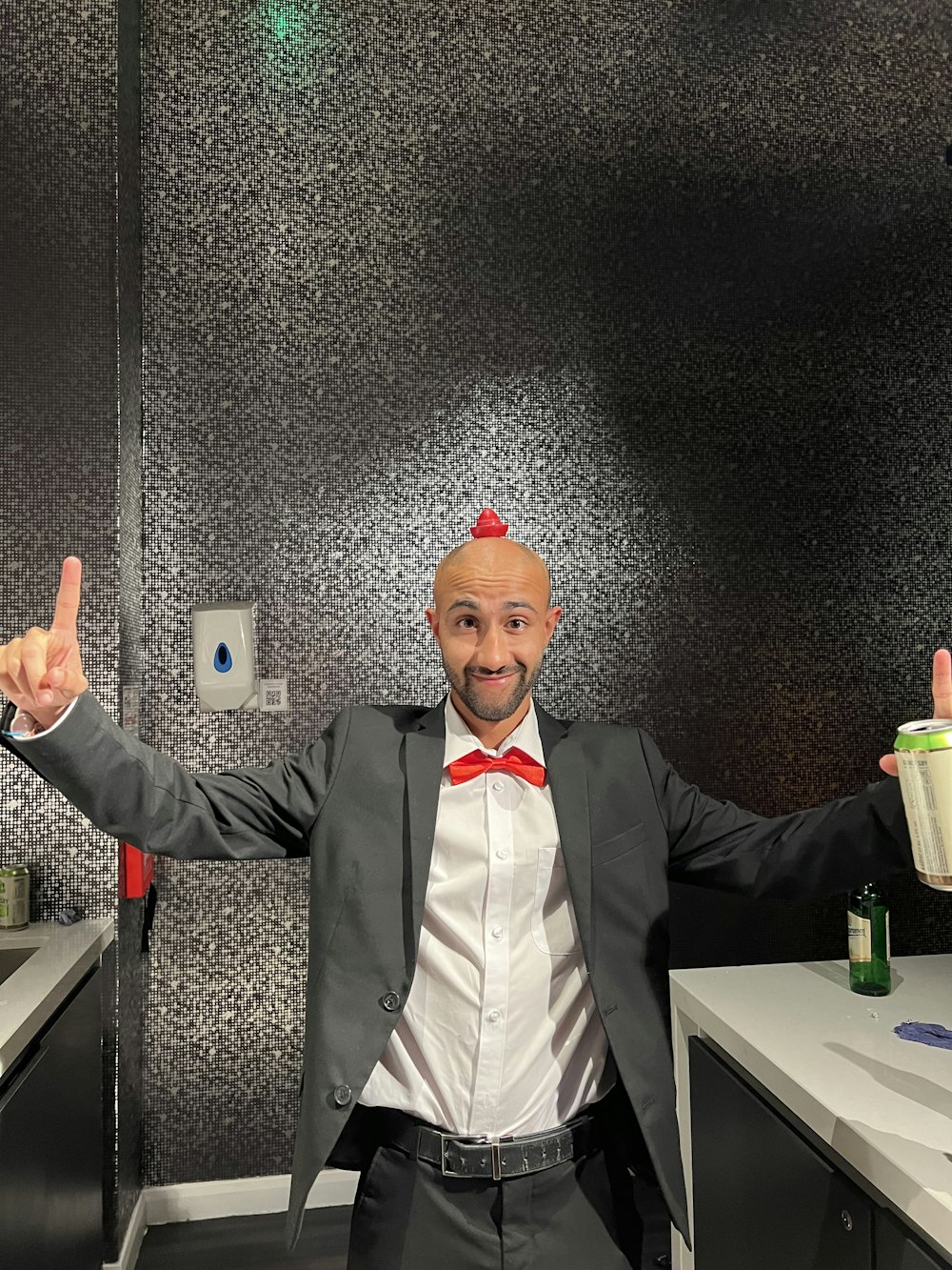 a man in a suit and bow tie standing in a room