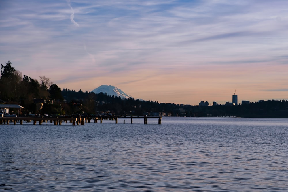 a body of water with a mountain in the background