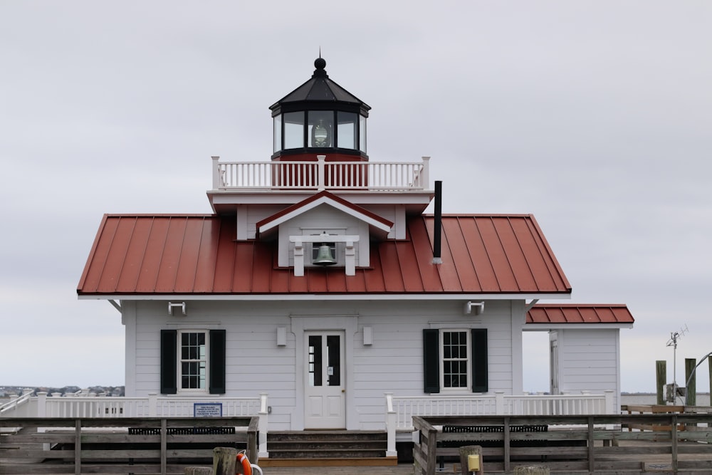 a small white building with a red roof