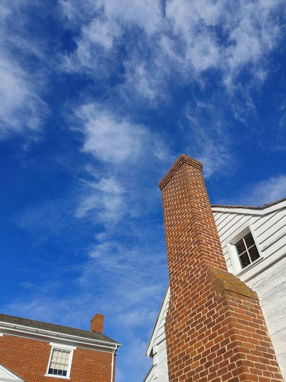 a tall brick chimney sitting next to a white building