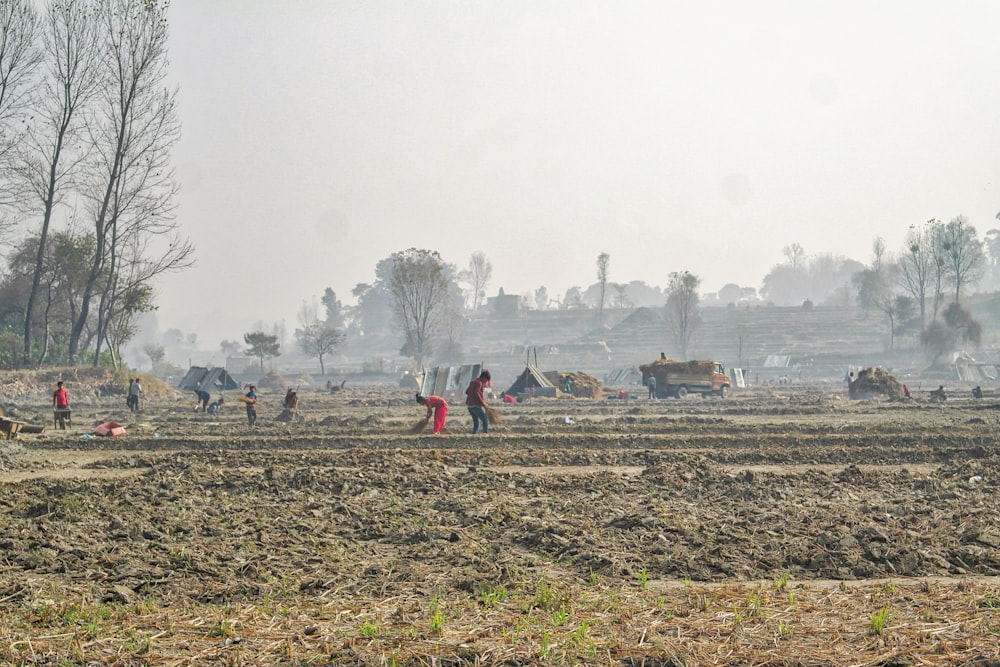 a group of people standing on top of a field