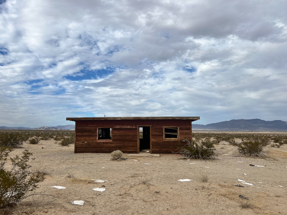 a small building in the middle of a desert