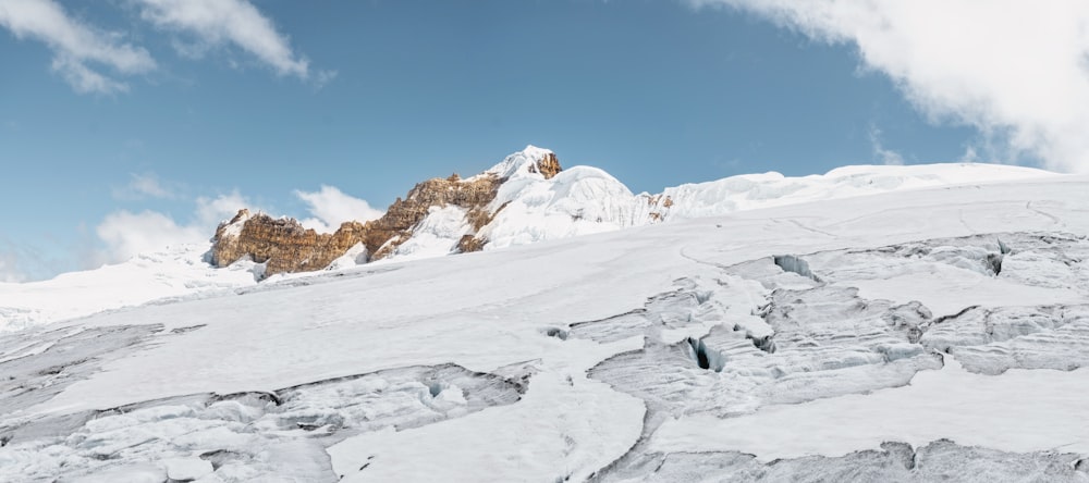 a man riding skis down a snow covered slope