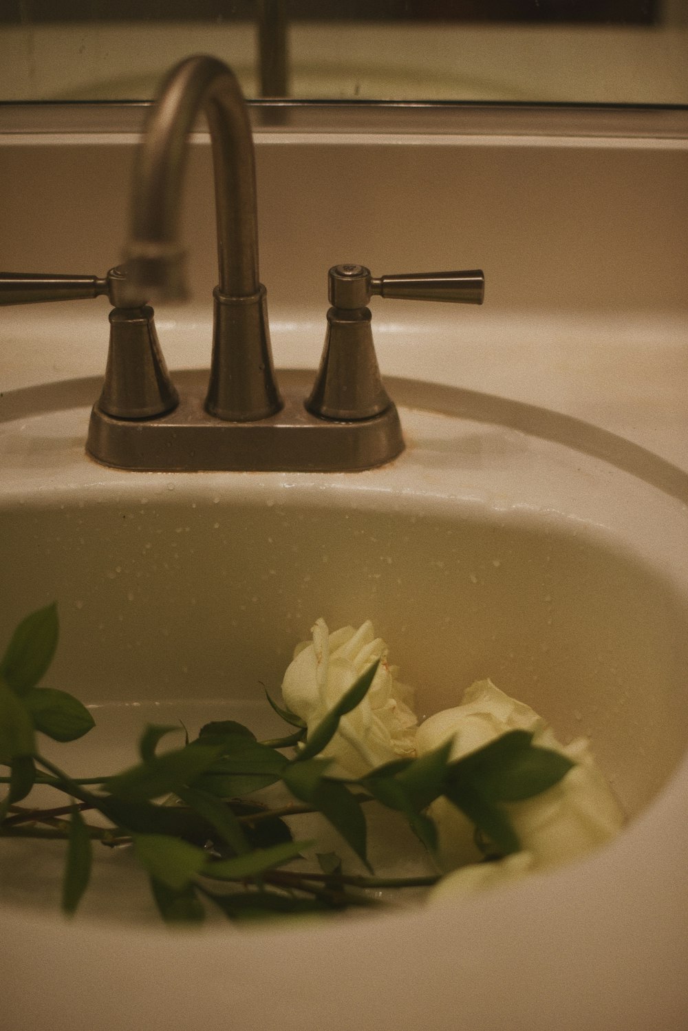 a sink with a bunch of flowers in it