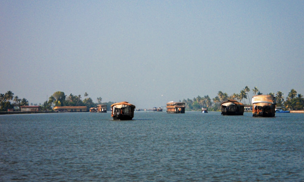 a group of boats floating on top of a lake