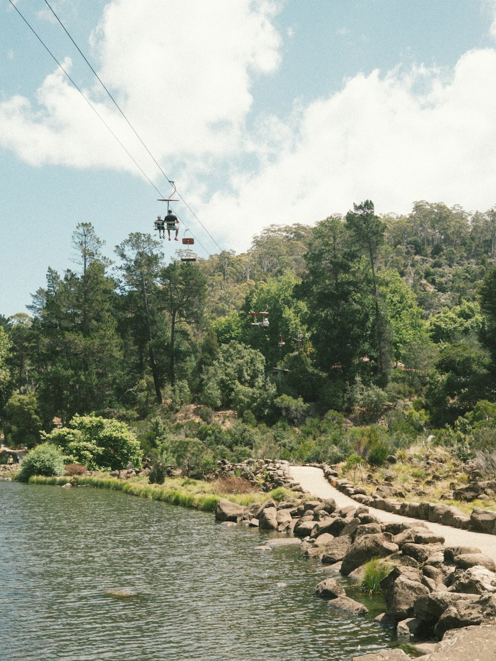 a view of a body of water with a ski lift in the background