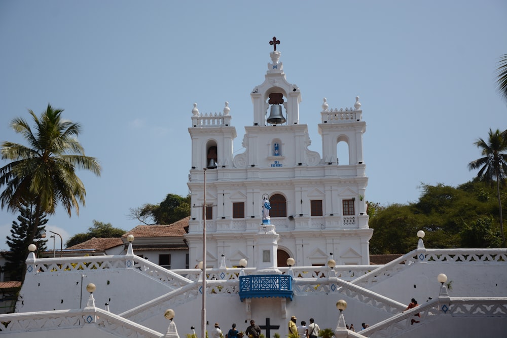 a large white building with a clock tower