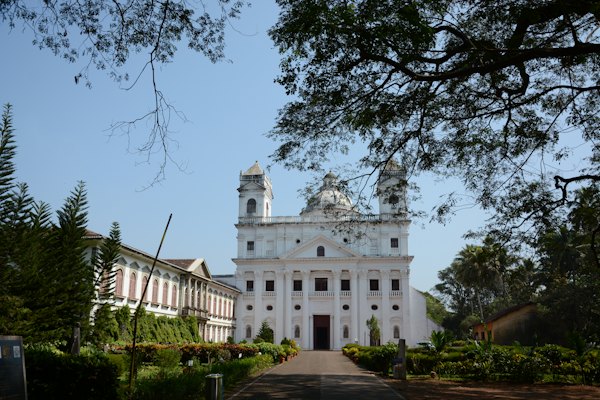 A large white building with a clock tower — Goa, India