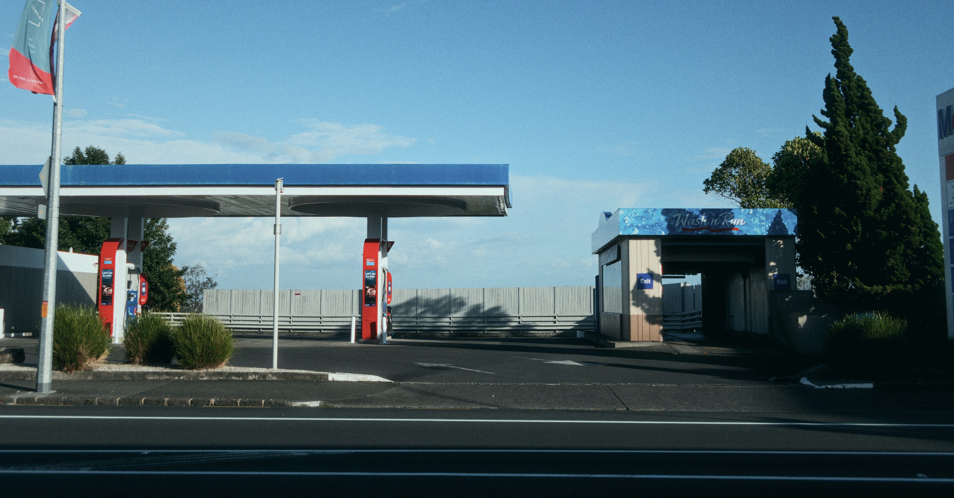 a gas station with a canadian flag on top of it
