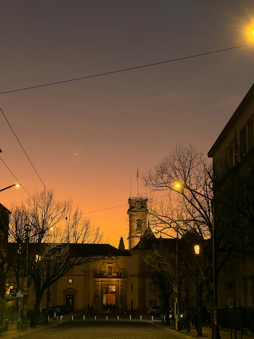 a city street with a clock tower in the background