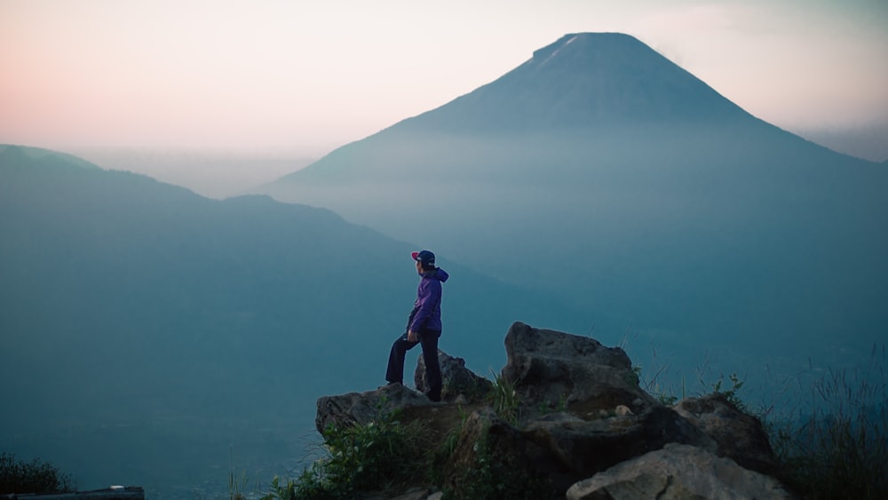 a man standing on top of a mountain