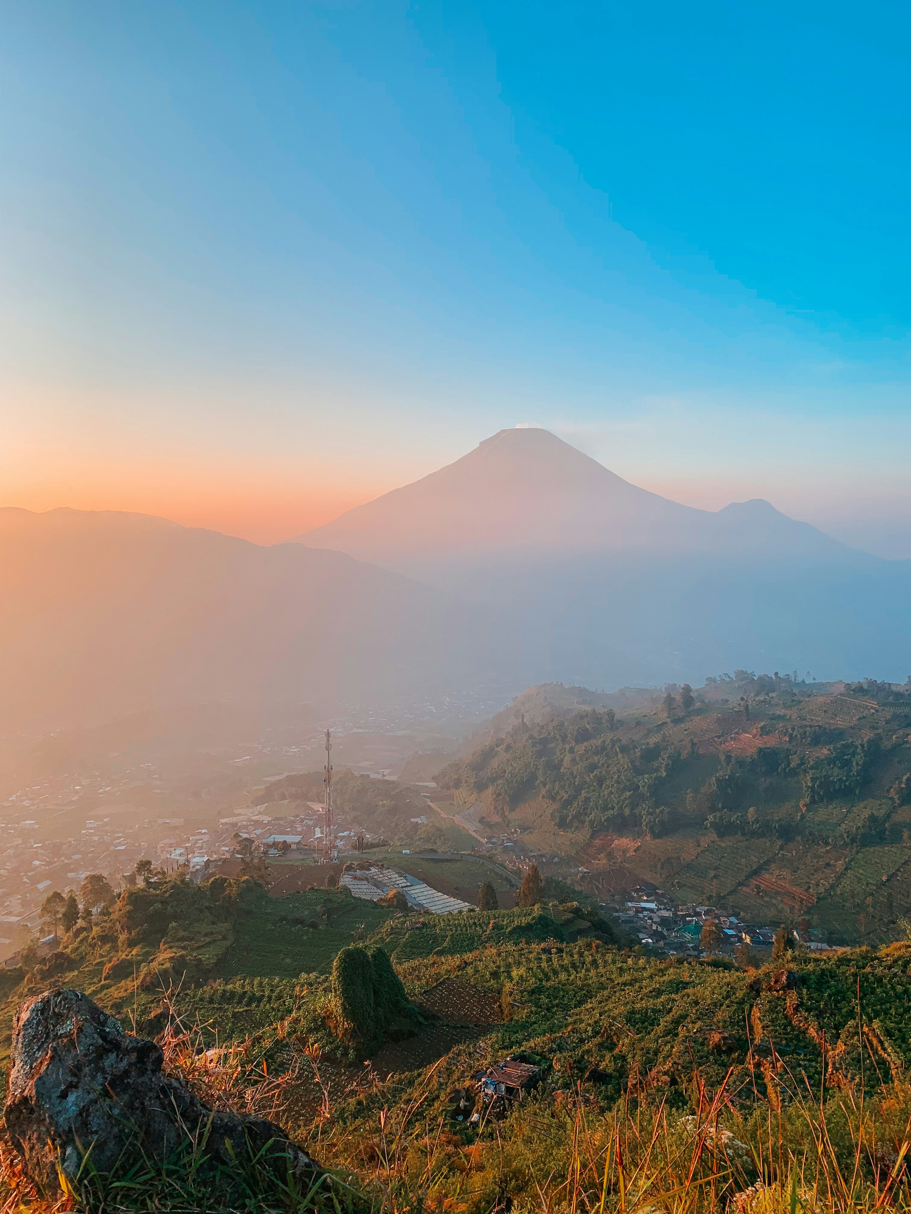 a view of a mountain with a sunset in the background
