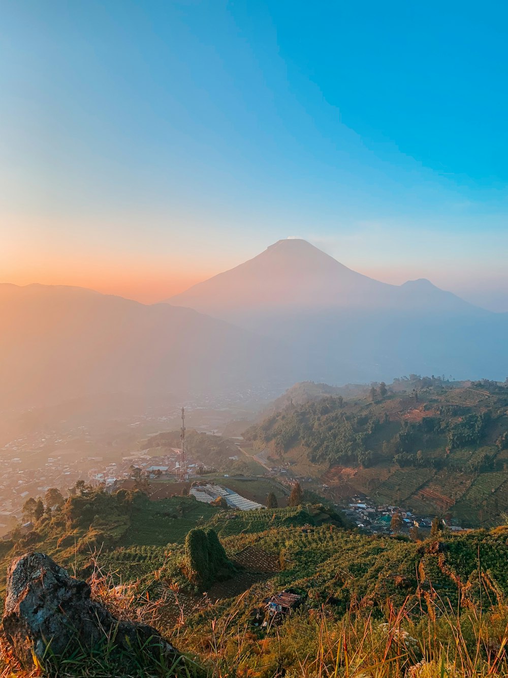 a view of a mountain with a sunset in the background