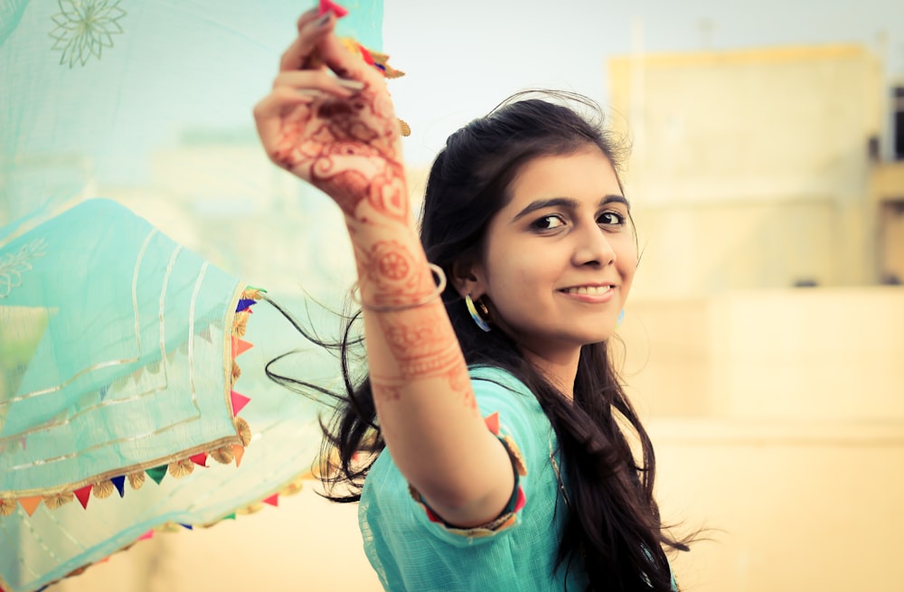 a woman holding a kite in her hand