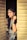 a woman with long hair standing in a doorway