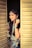 a woman with long hair standing in a doorway