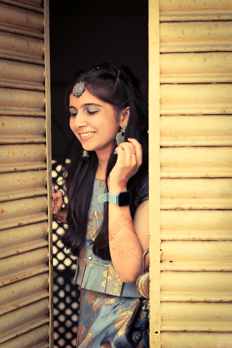 A woman with long hair standing in a doorway