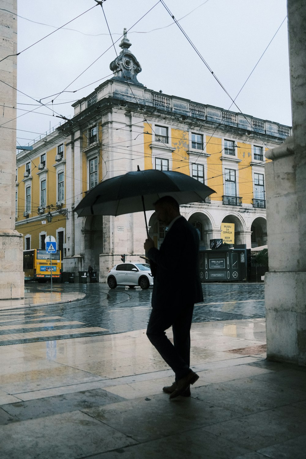 a man walking down a street holding an umbrella