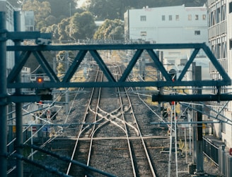 a view of a train track with buildings in the background