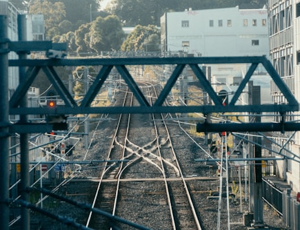 a view of a train track with buildings in the background